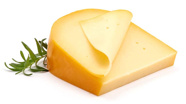 A slice of Gouda cheese with a sheet cut from it